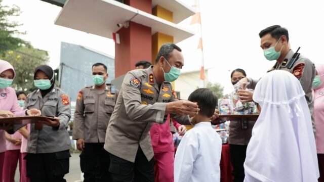 Anggota Polda Sumsel membagikan masker kepada warga untuk melindungi dari asap karhutla