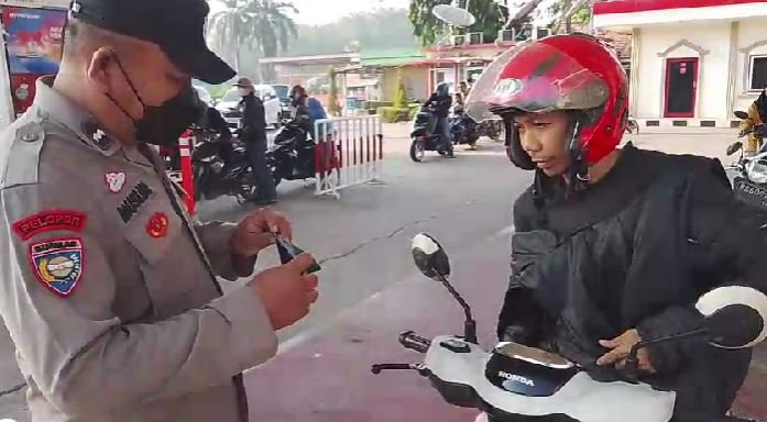 Jaga Kesehatan Warga, Bhabinkamtibmas Kelurahan Alang-Alang Lebar Imbau Pemakaian Masker di SPBU Bypass